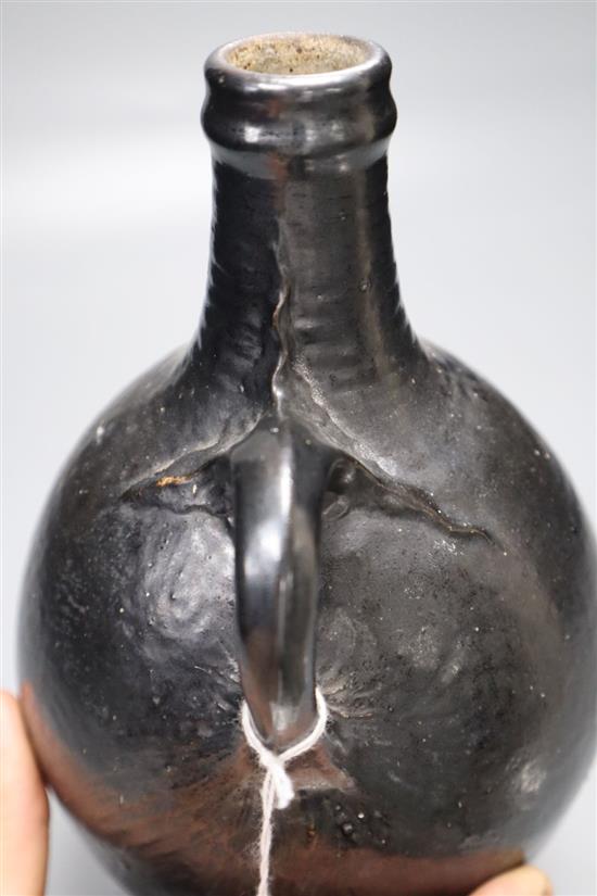 A Martin Brothers black glazed flagon, signed and dated 1909, height 23cm